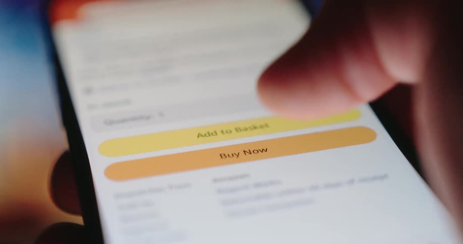 A finger taps the buy now button on a smartphone screen displaying a product during online shopping