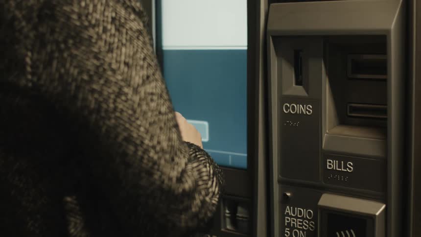 A woman wants to marry brown by putting a banknote into an automatic teller machine