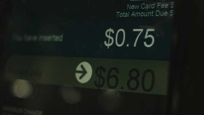 A person interacts with the screen of a pointofsale terminal displaying transaction details