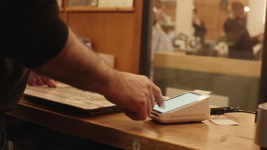 Hand setting up a payment machine