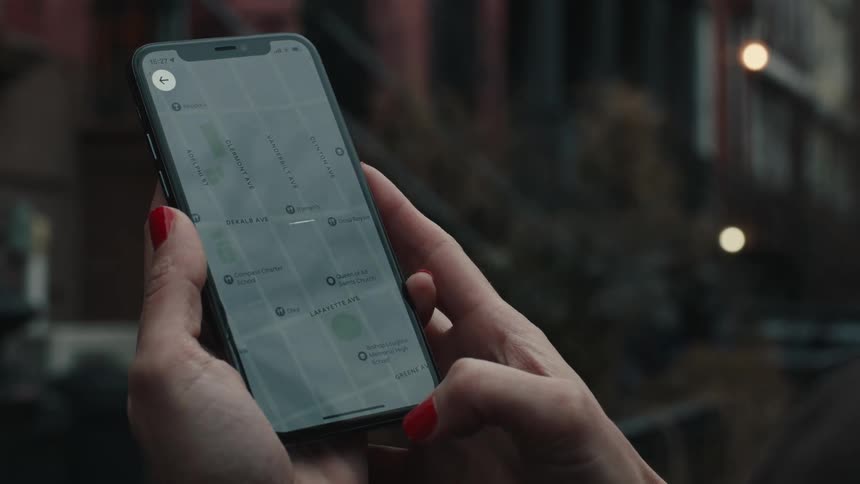 A woman is using an app to get a ride