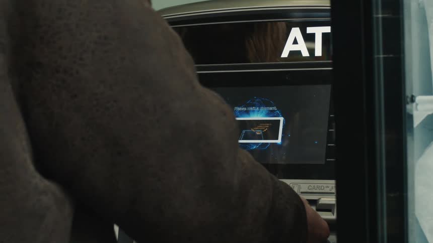 A person interacts with an atm machine