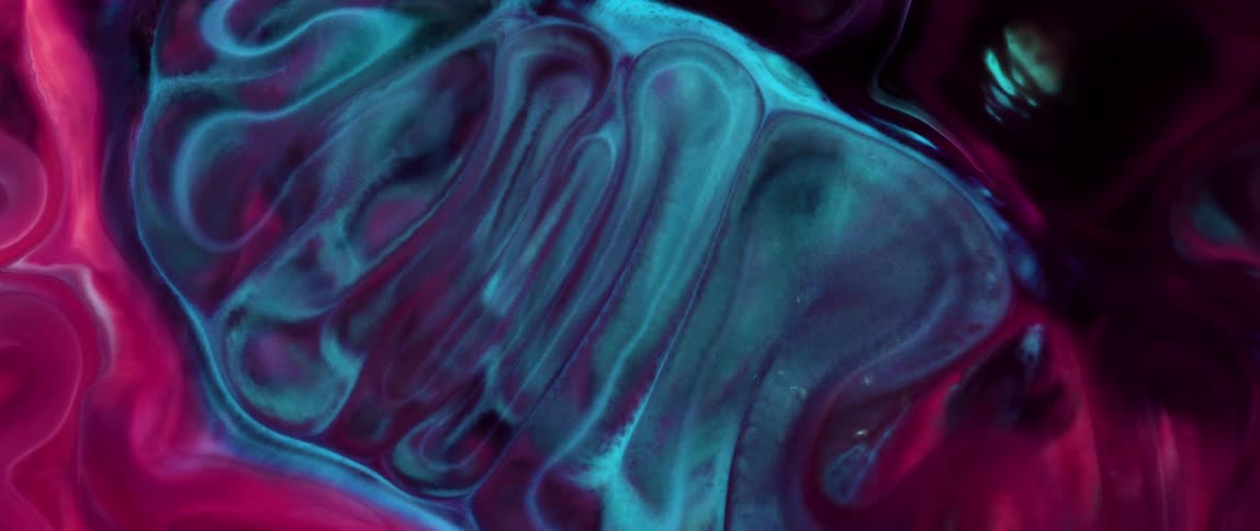 Blue portion expands in the middle of a red and blue mixture against a black background