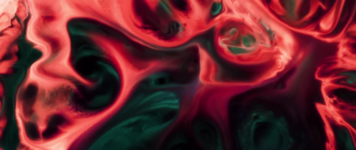 A vibrant and abstract pattern with swirling red and green hues resembling fluid in motion