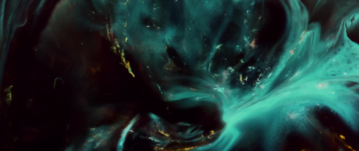 Abstract shot of colors as they swirl expand and morph into different shapes