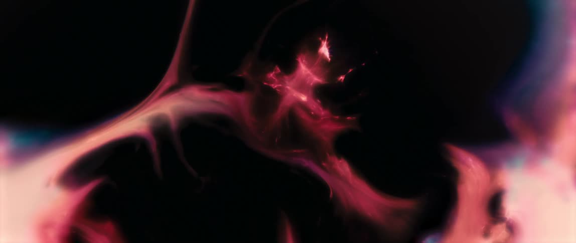 Abstract pink texture expanding and fading against a black background