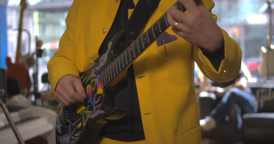 Person playing guitar inside a store