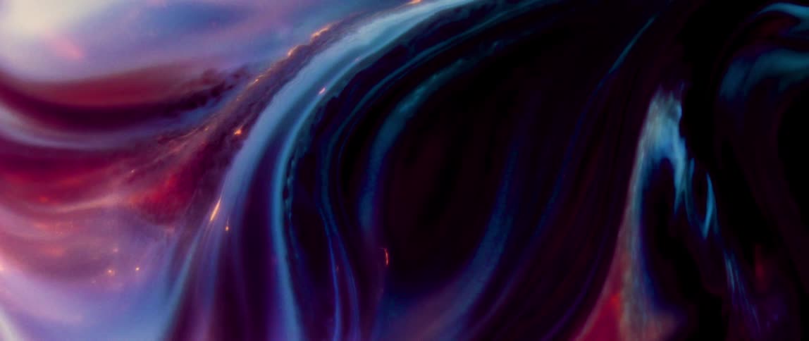 Abstract waves of vibrant blue and purple hues swirl and blend together creating a sense of movement and depth
