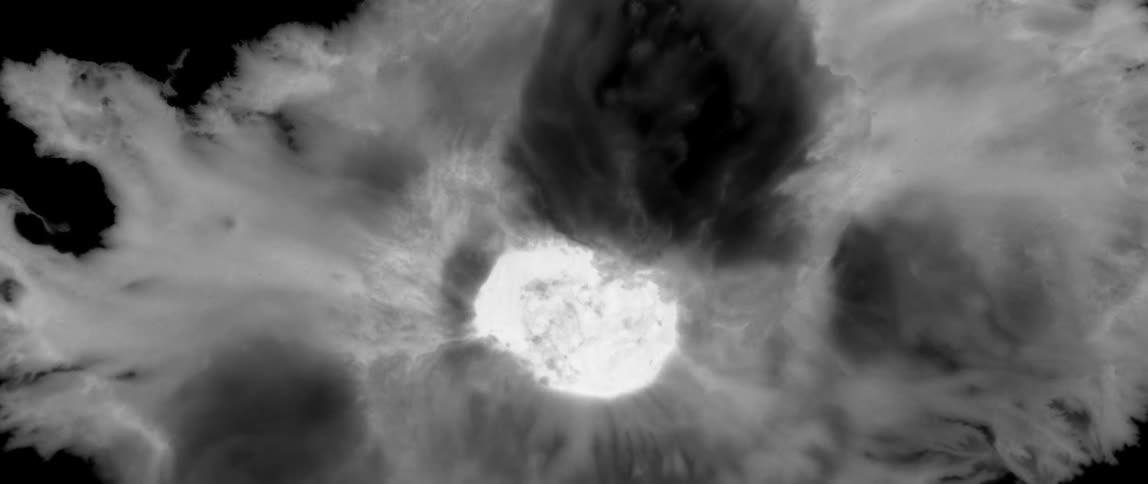 A bright glowing white area surrounded by swirling dark and light gray clouds