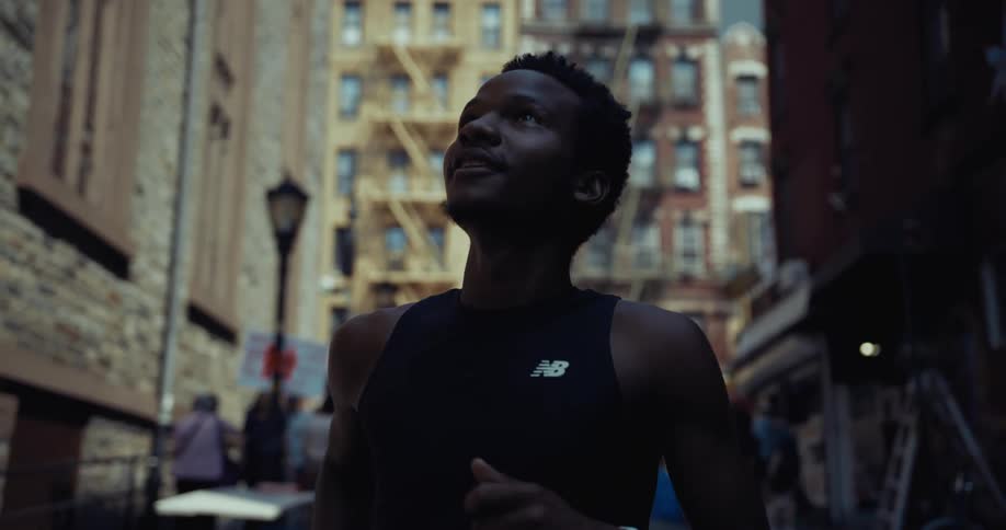 A man is jogging in the middle of a city street