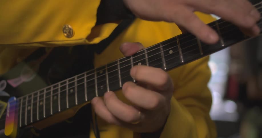 Pair of hands playing guitar