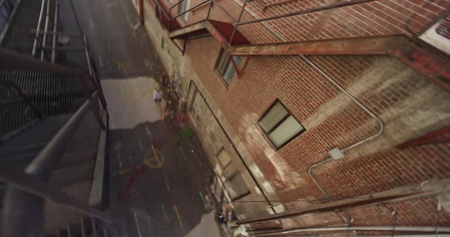 Person running down an urban alley