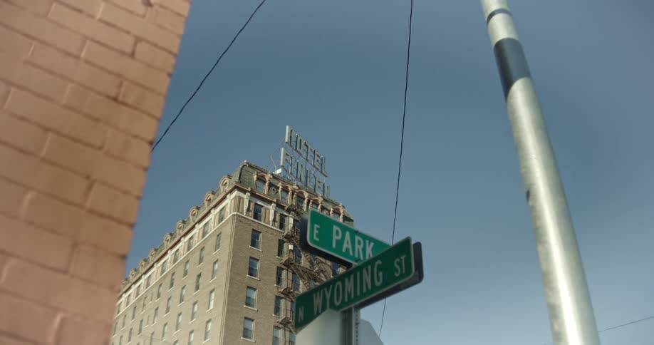 Street sign in a metropolis with a building in the background