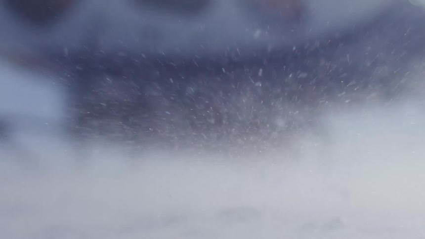 Snow flying on a ground with intense wind