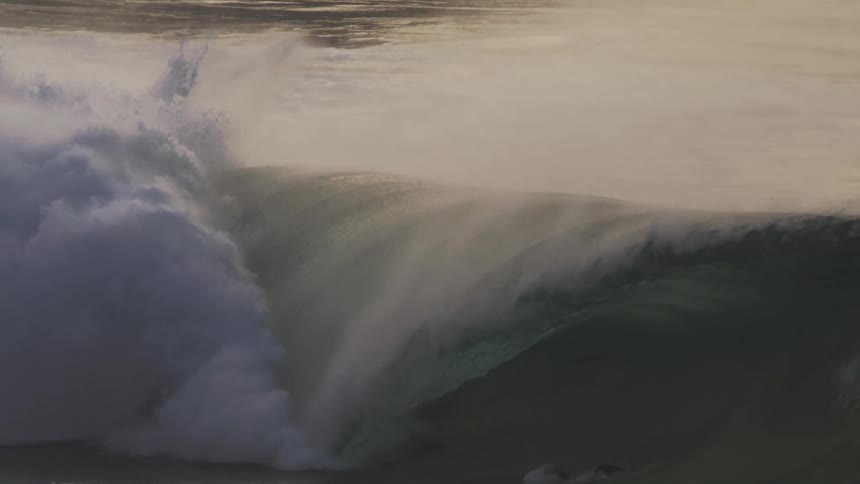 Surfer riding a strong wave