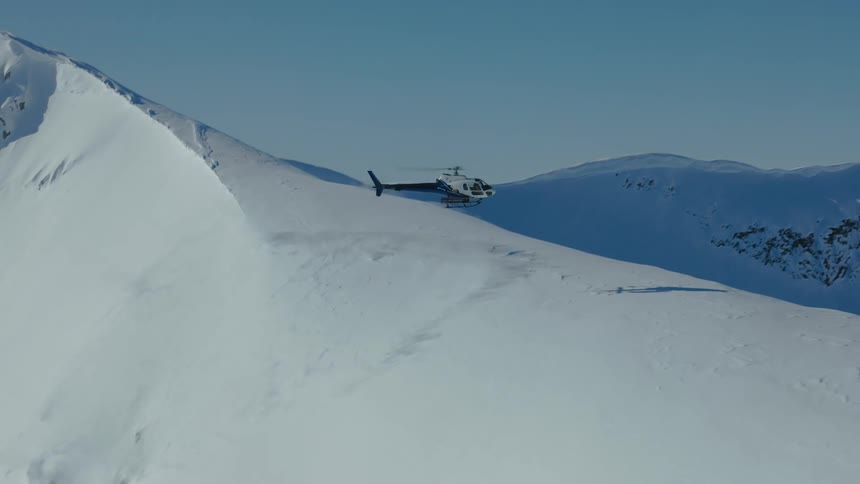 A footage of a chopper landing on the peak on an ice mountain