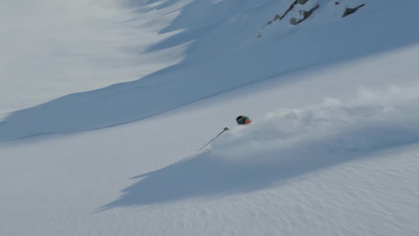 Person skiing down a snowy mountain