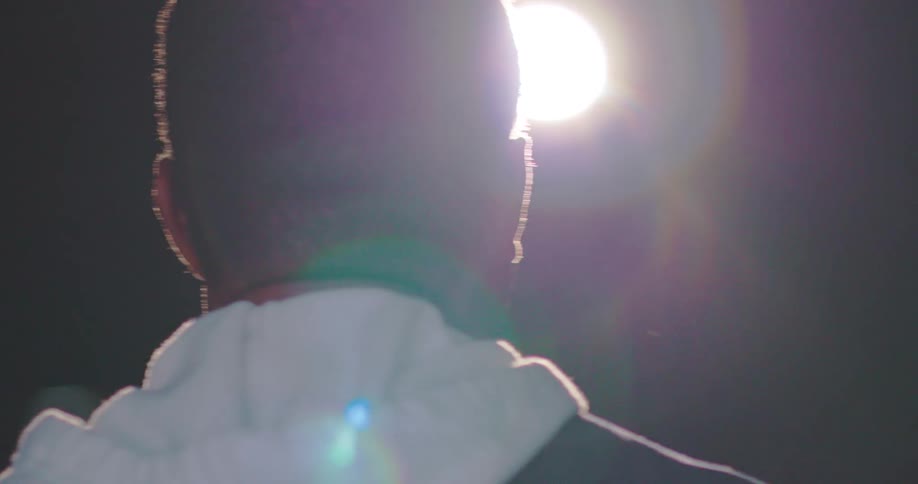 A back view of a man standing on the stage