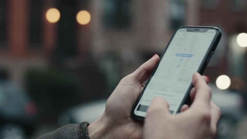 Close up of a pair of hands making payment via smartphone