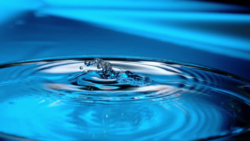 A drop falling on a water surface and making some ripples