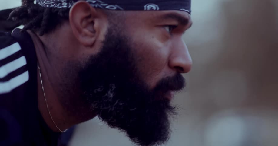 Side portrait of a bearded man with a concentrated look