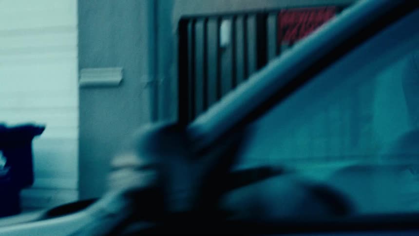 A car passes a man that is jogging
