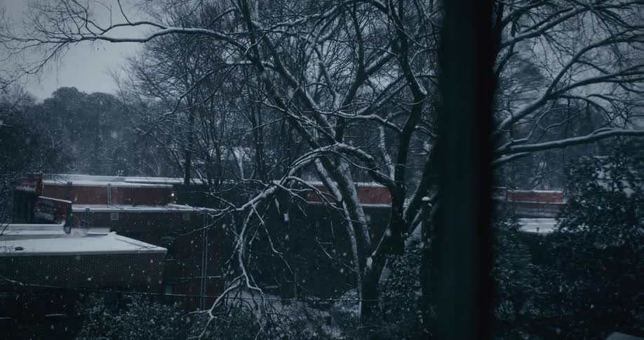 Urban city on a snowy day seen through a window