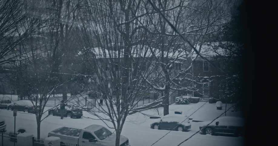 View through a window of an urban neighborhood on a snowy day