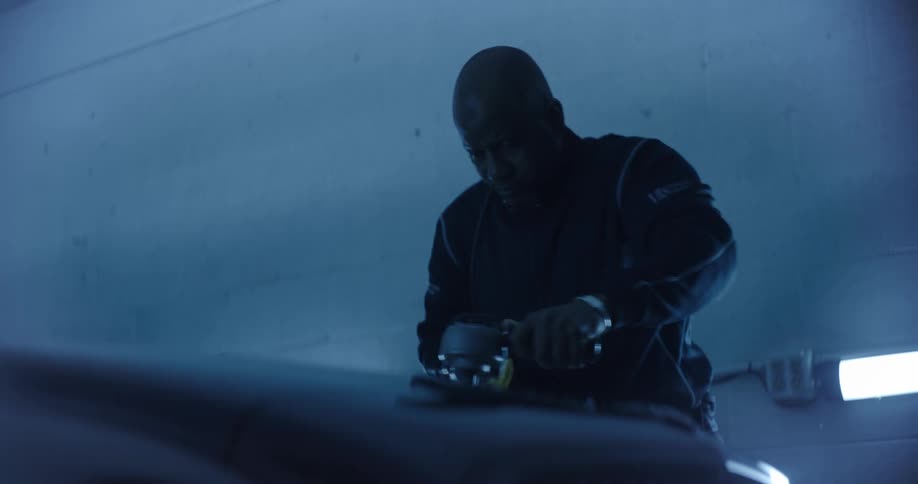 Man polishing the roof of a vehicle