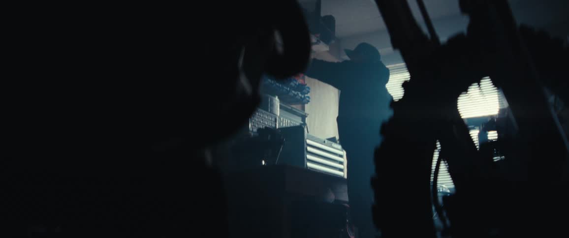 Silhouette of a man working in a workshop