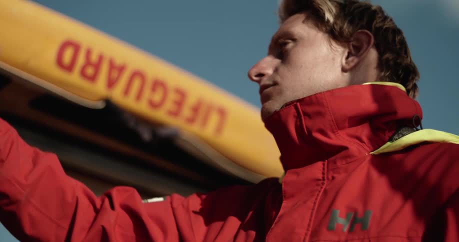 Man in a red jacket walking outdoors