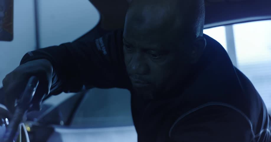 Man cleaning the inside of a vehicle