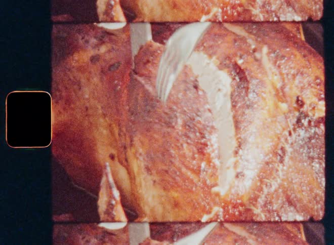 A closeup shot of a roasted turkey being carved with a knife and fork captured on vintage film