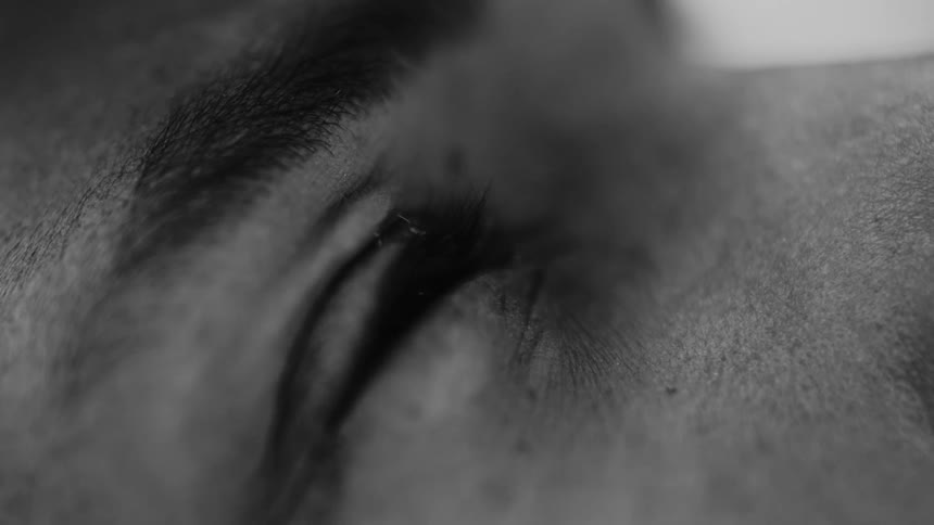 Water droplet falling towards a persons eye