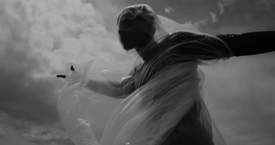 A man is covered in a plastic sheet