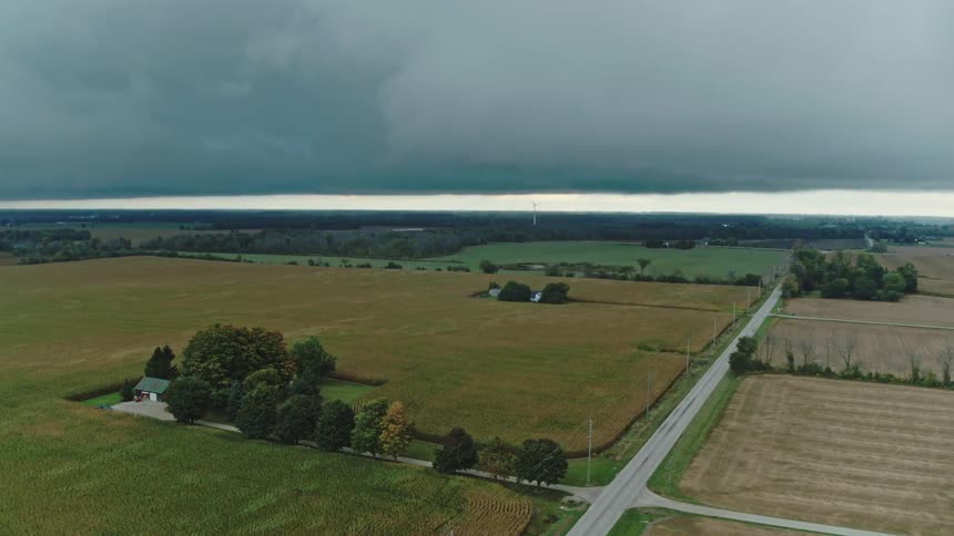 Aerial view of a country road in the middle of farm land on a stormy day