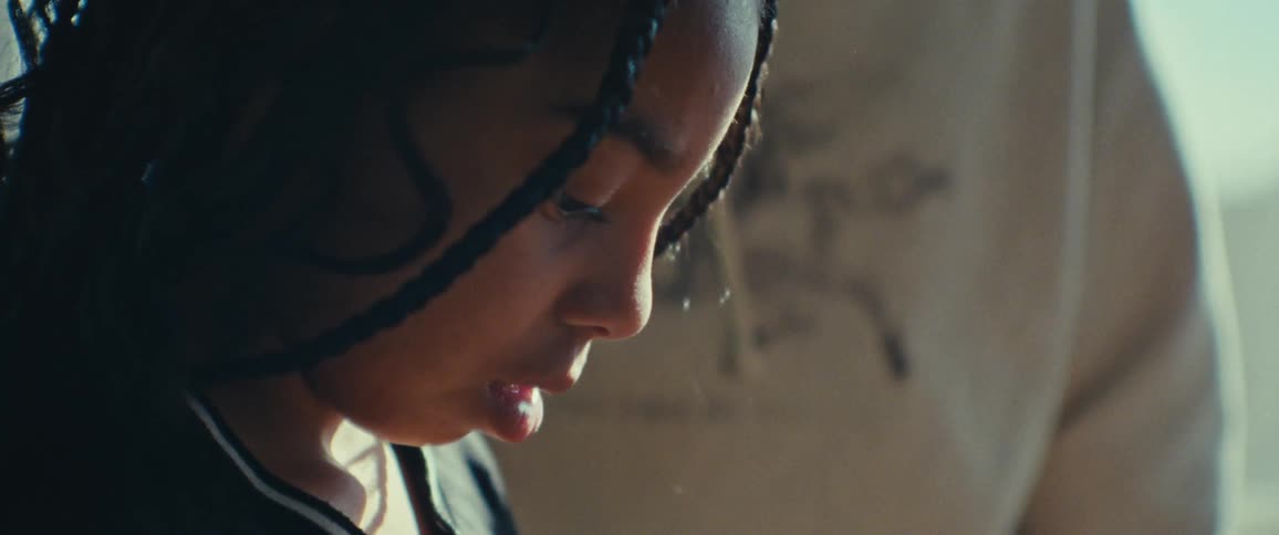Closeup of a girl mixing colorful oil paints on a palette in a sunlit room