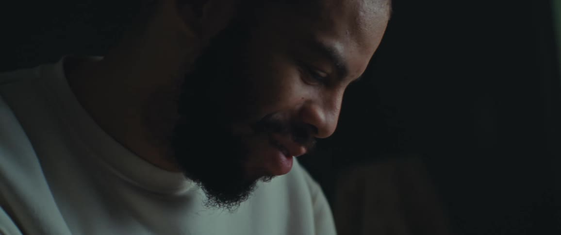A man smiles while reading