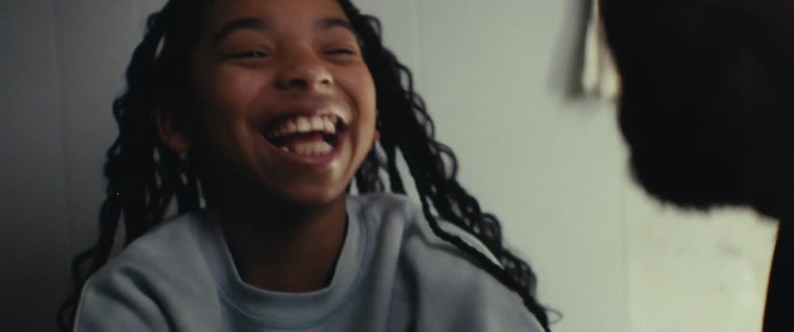 Portrait of a girl laughing out loud while talking to someone else