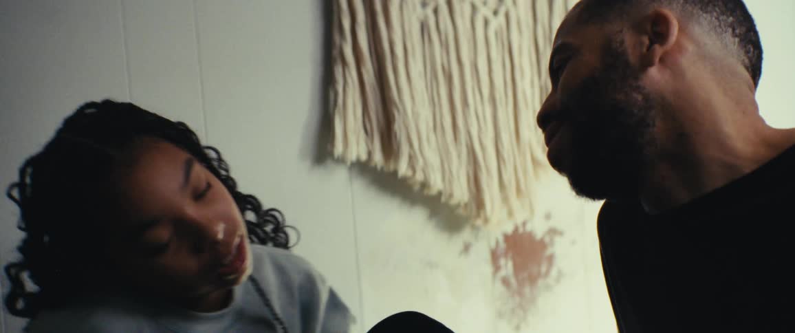 A father talks with his daughter and she begins laughing