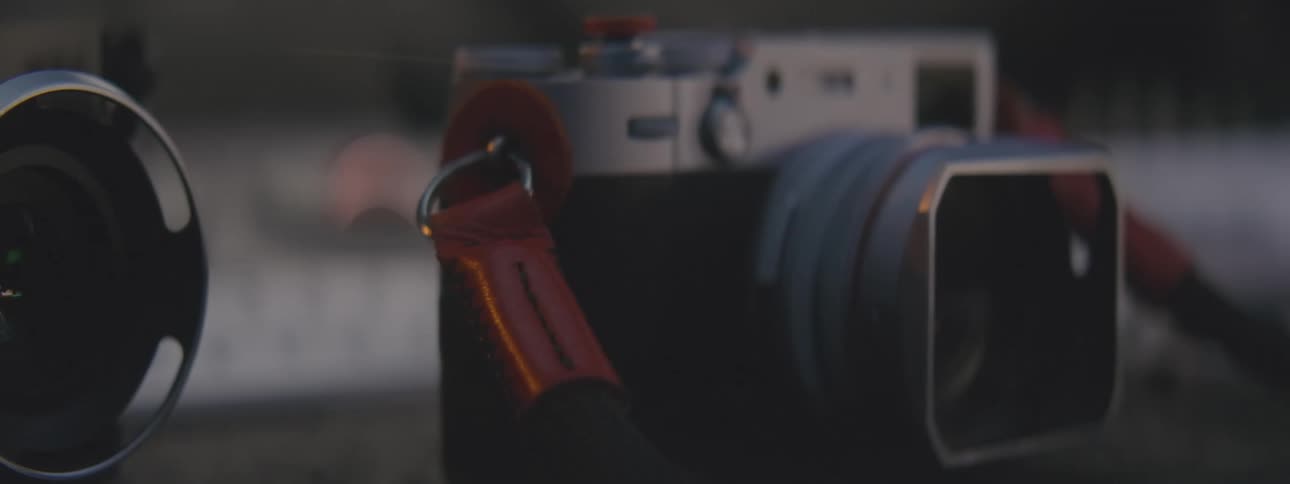 Hand picking up a camera by the handle and returning it to the same place