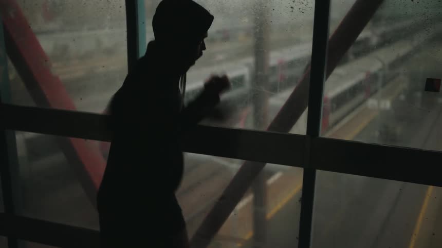 Hooded person throwing boxing punches