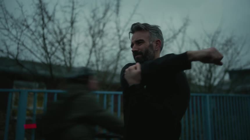 A man stops running to stretch
