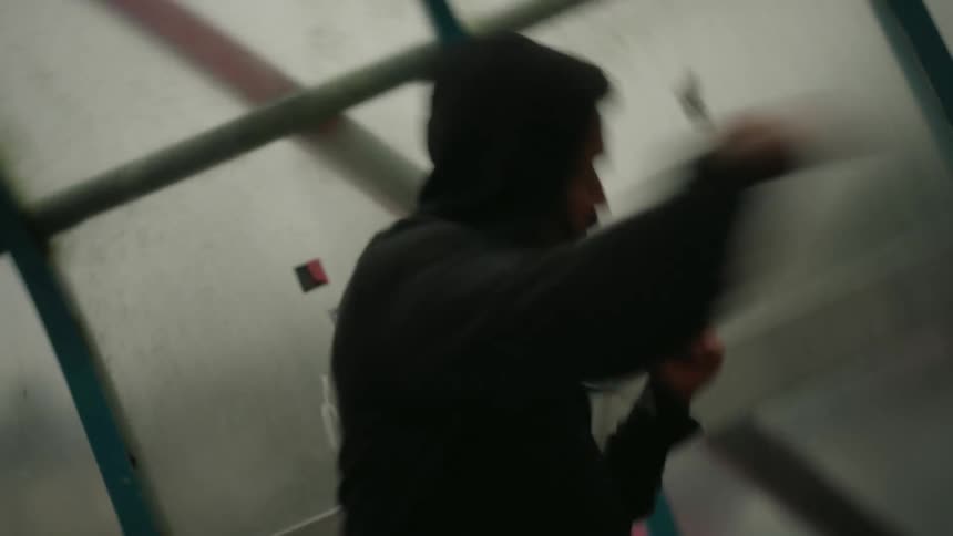 Man inside a hallway throwing boxing punches
