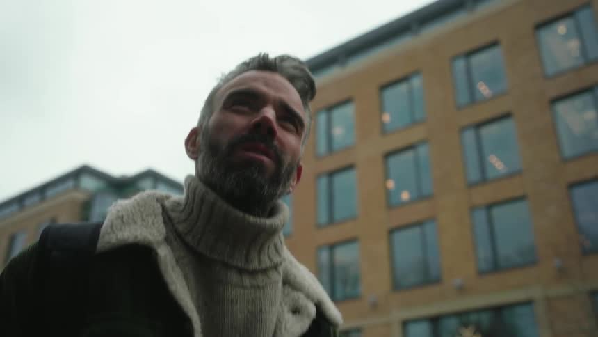 Bearded man walking through the city