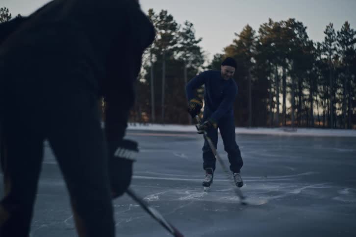 Two men are passing the puck back and forth