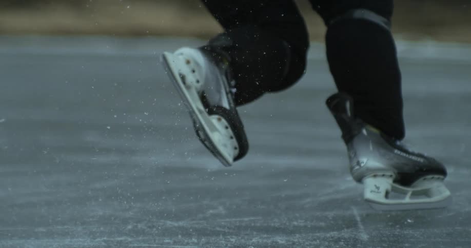 Ice skates glide quickly over a frozen surface