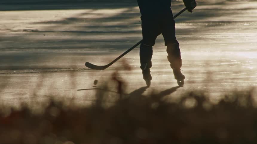 Lonely man playing ice hockey