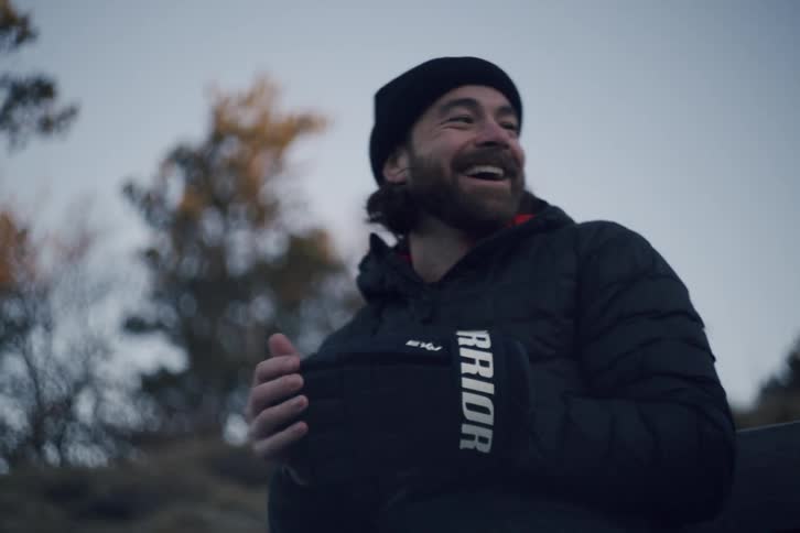 Man smiling while holding something in his hands