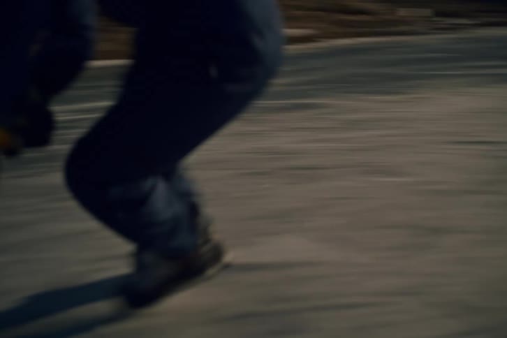 A man is playing ice hockey on a sunny day